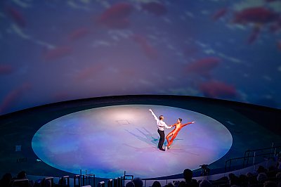 Long Beach Ballet performers dance on a round stage - thumbnail