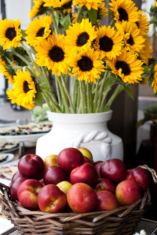 sunflowers with a basket of apples